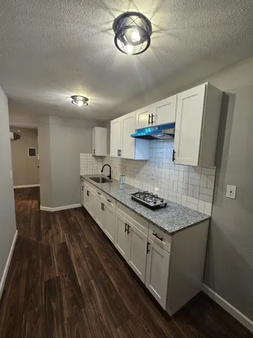 a kitchen with stainless steel appliances granite countertop a stove and a sink