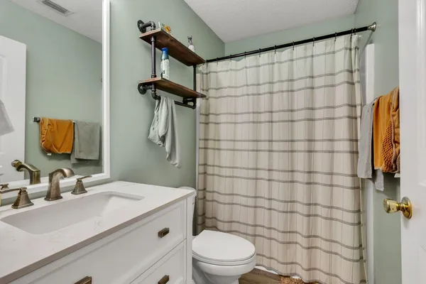 a bathroom with a sink toilet and shower