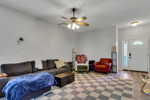 a living room with furniture and a chandelier