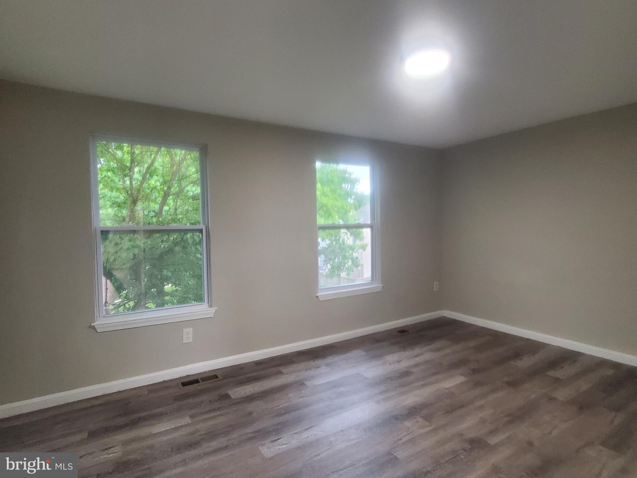 14813 Hammersmith Circle Silver Spring, MD 20906 - Photo 12 of 36 an empty room with wooden floor and windows