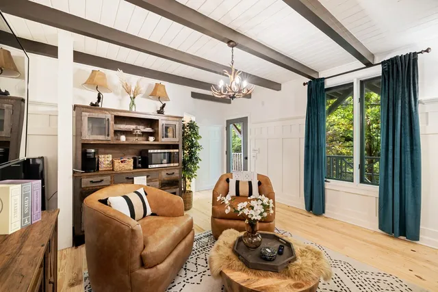 a dining room with furniture and wooden floor