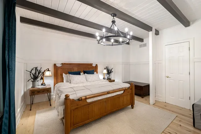 a view of a balcony with chairs and wooden floor