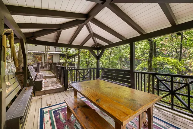 a view of balcony with wooden floor and fence