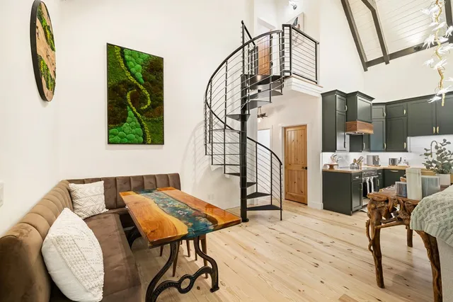 a kitchen with stainless steel appliances granite countertop a sink a stove and wooden floors