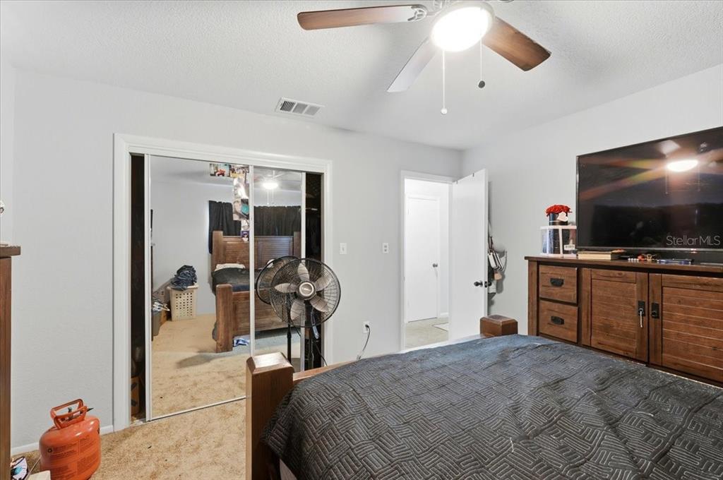 54 Gardner Avenue Lake Wales, FL 33898 - Photo 12 of 25 a bedroom with a bed and a flat screen tv