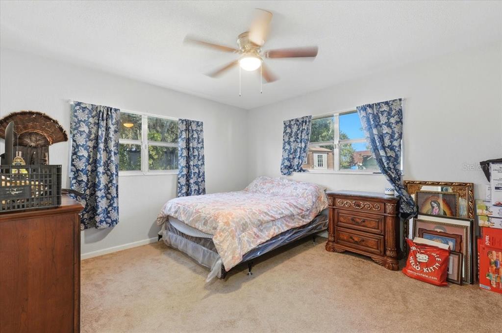 54 Gardner Avenue Lake Wales, FL 33898 - Photo 17 of 25 a bedroom with a bed and a flat tv screen on the dresser