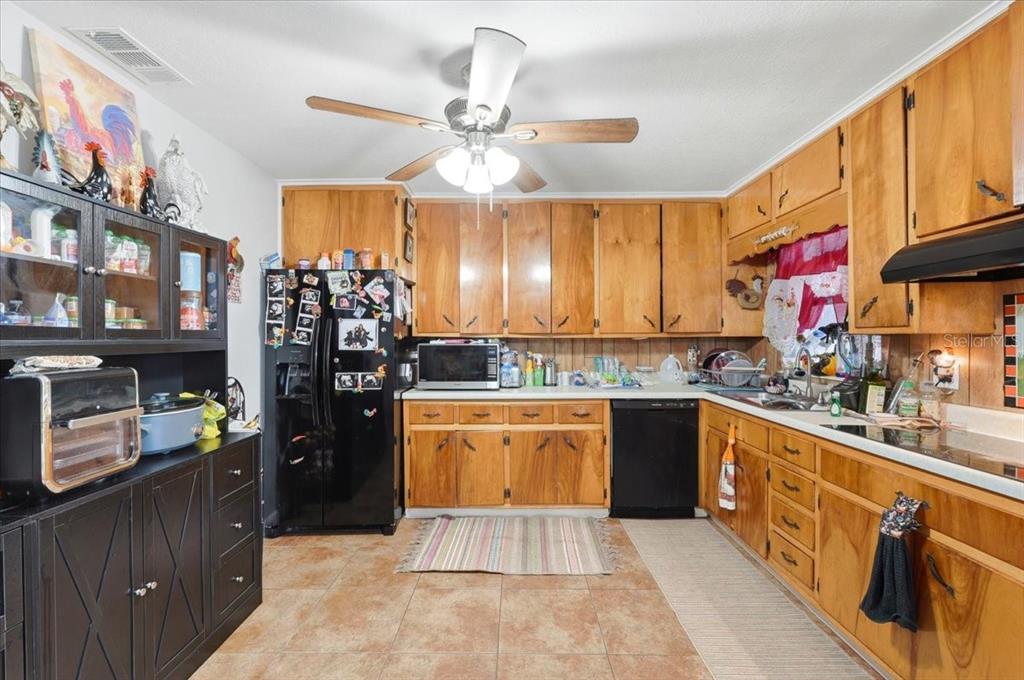 54 Gardner Avenue Lake Wales, FL 33898 - Photo 4 of 25 a kitchen with stainless steel appliances granite countertop a sink and cabinets