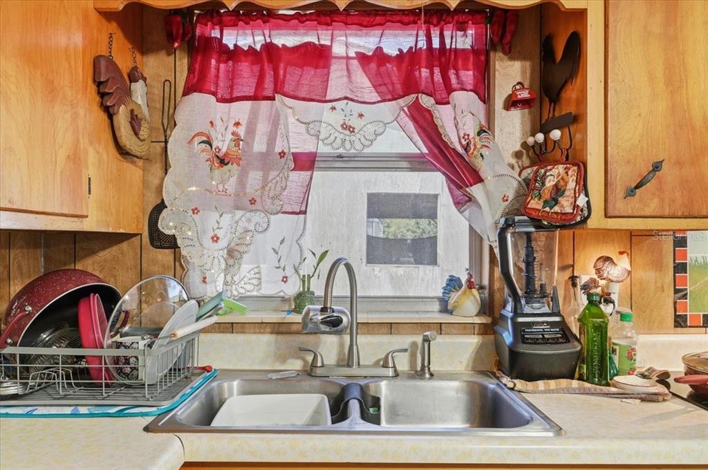 54 Gardner Avenue Lake Wales, FL 33898 - Photo 5 of 25 a kitchen with a sink and a stove with wooden floor