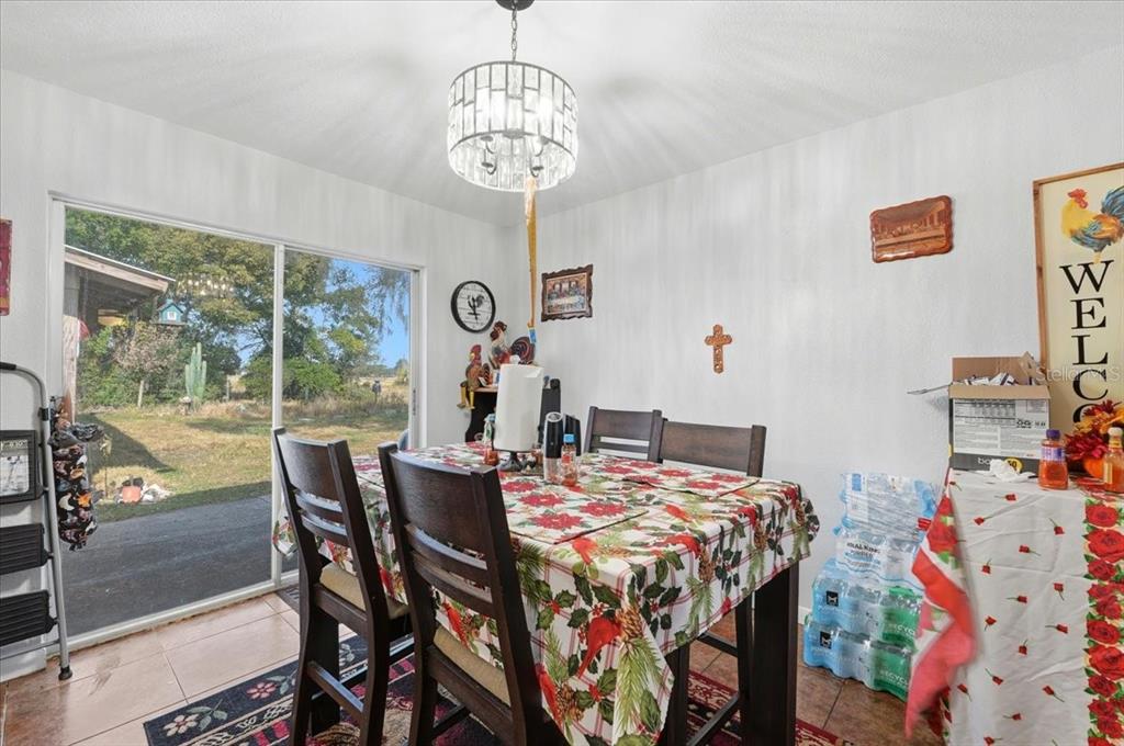 54 Gardner Avenue Lake Wales, FL 33898 - Photo 7 of 25 a view of a dining room with furniture window and outside view