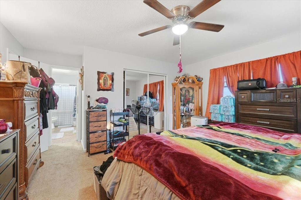 54 Gardner Avenue Lake Wales, FL 33898 - Photo 9 of 25 a bed room with a bed mirror and a window