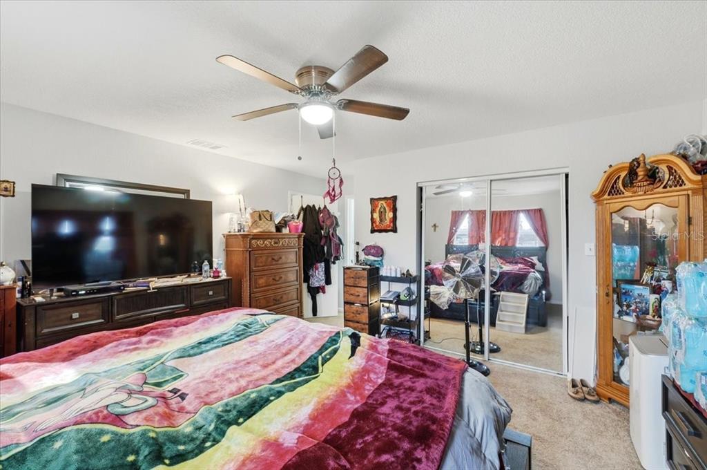 54 Gardner Avenue Lake Wales, FL 33898 - Photo 10 of 25 a living room with lots of furniture and a flat screen tv