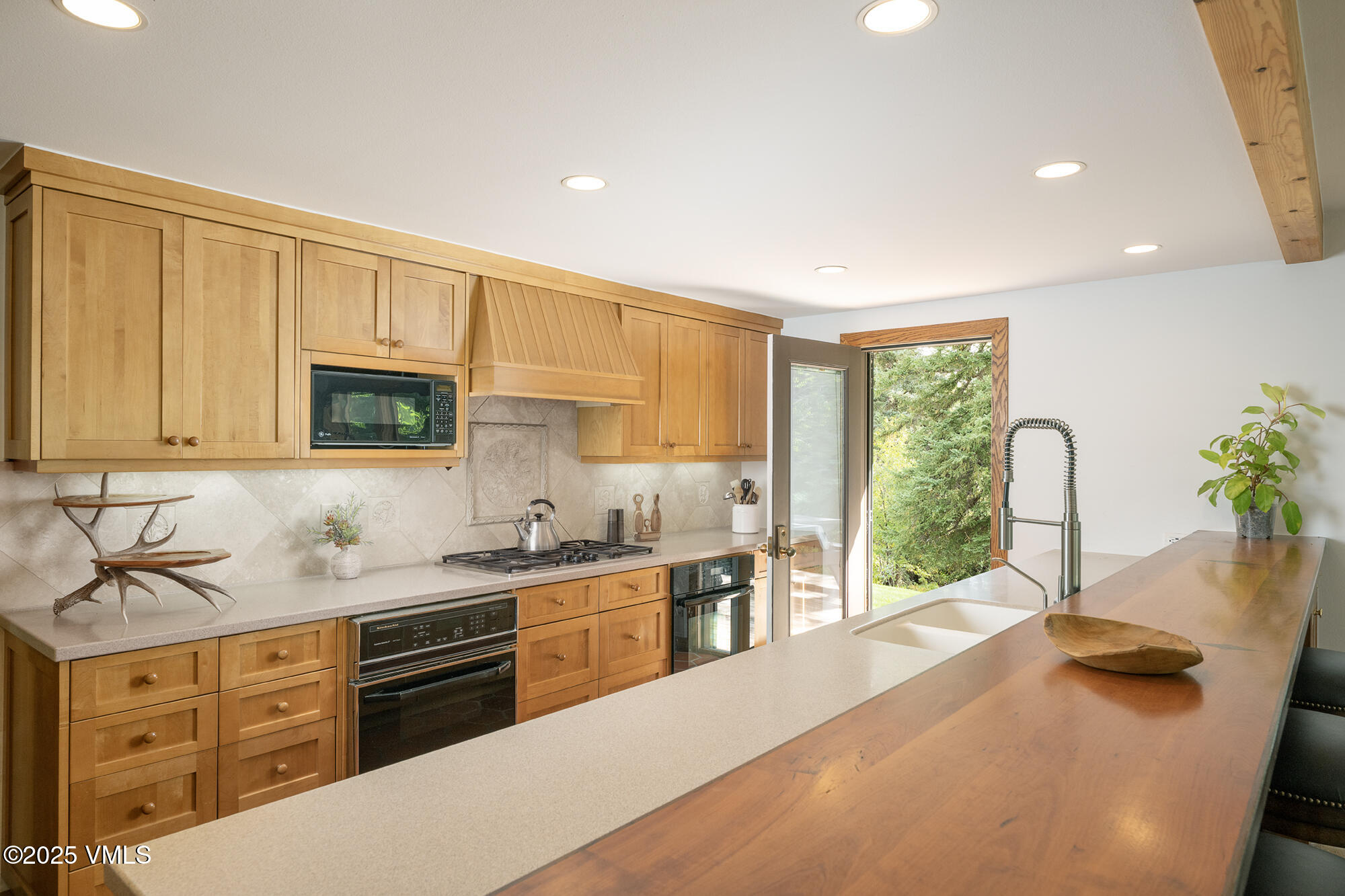 304 Meadow Road Edwards, CO 81632 - Photo 11 of 25 a kitchen with stainless steel appliances a sink window and cabinets