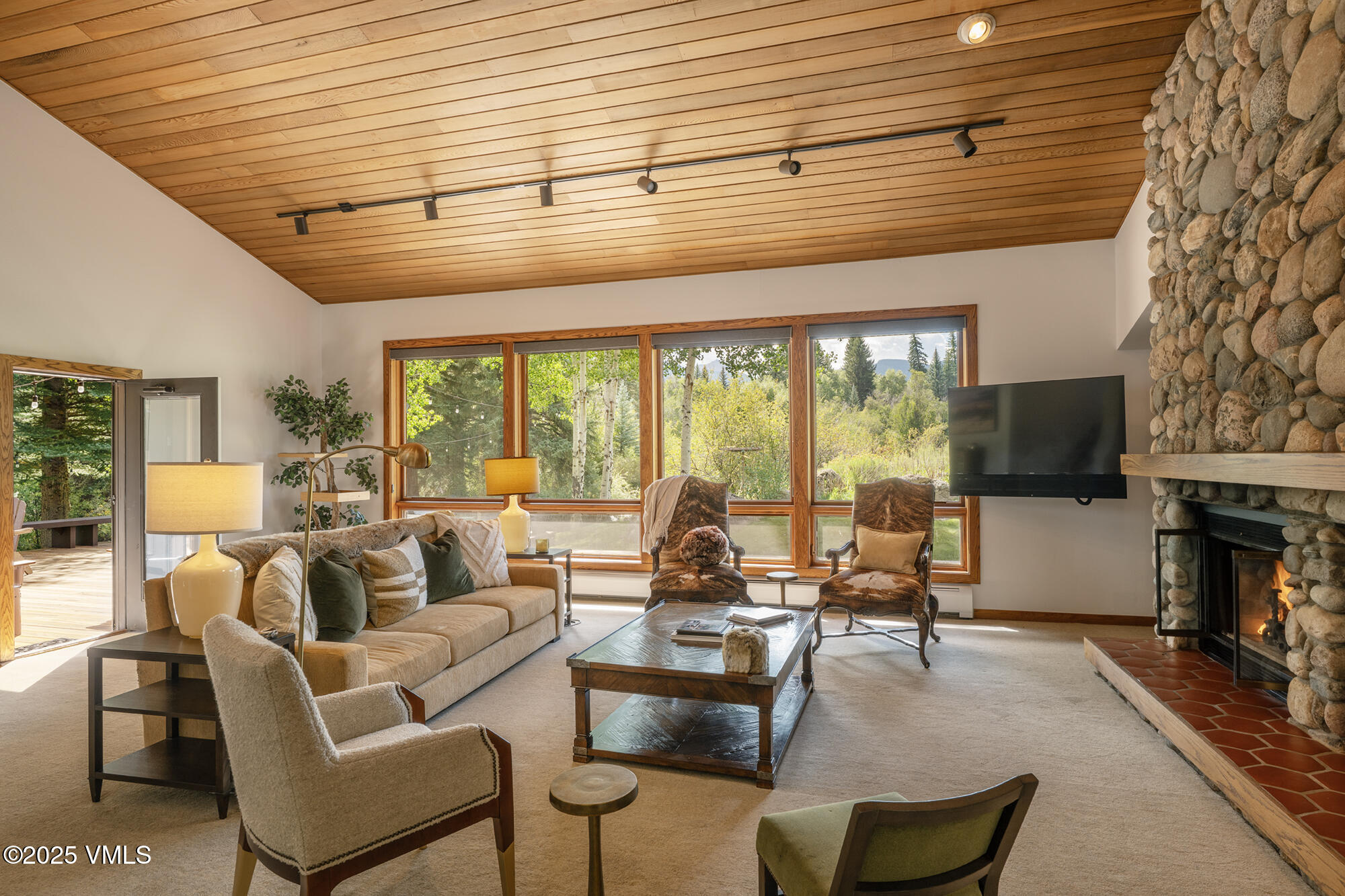 304 Meadow Road Edwards, CO 81632 - Photo 9 of 25 a living room with furniture a flat screen tv and a large window