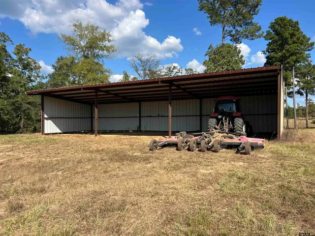 a view of a two chair in the patio and a car parked