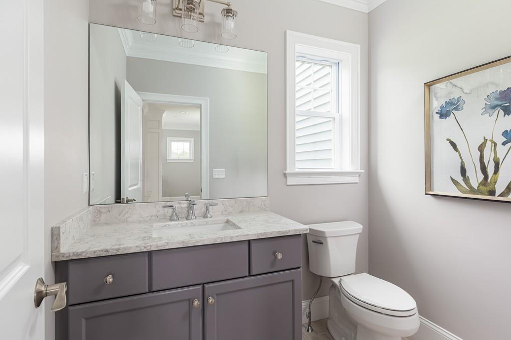 7 Summit Pointe Drive Holliston, MA 01746 - Photo 11 of 24 a bathroom with a granite countertop toilet sink and mirror
