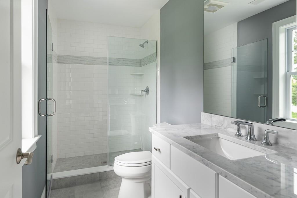 7 Summit Pointe Drive Holliston, MA 01746 - Photo 21 of 24 a bathroom with a granite countertop sink toilet and shower