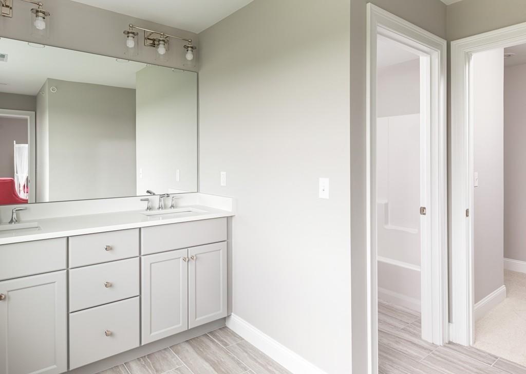 7 Summit Pointe Drive Holliston, MA 01746 - Photo 23 of 24 a bathroom with a double vanity sink and a mirror
