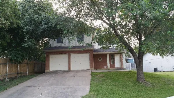 a front view of house with a garden