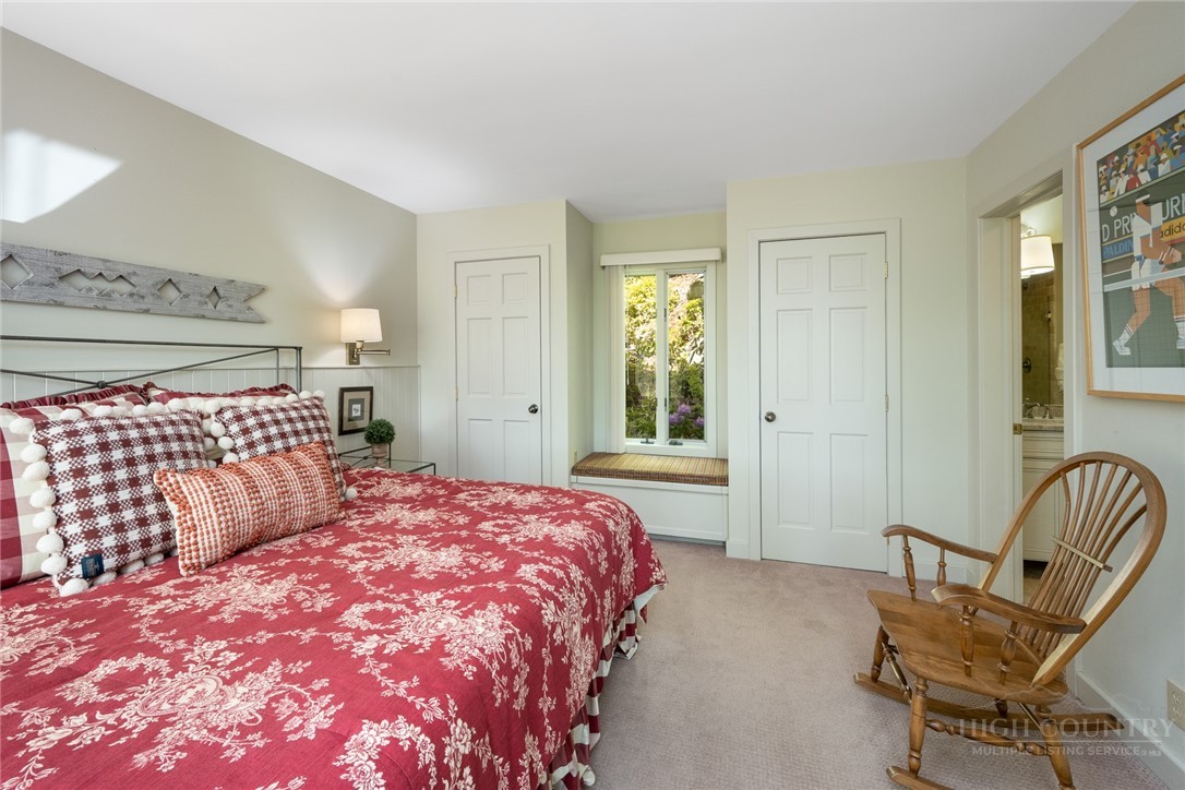 246 Mulberry Lane Boone, NC 28607 - Photo 36 of 49 a bedroom with a bed and chair