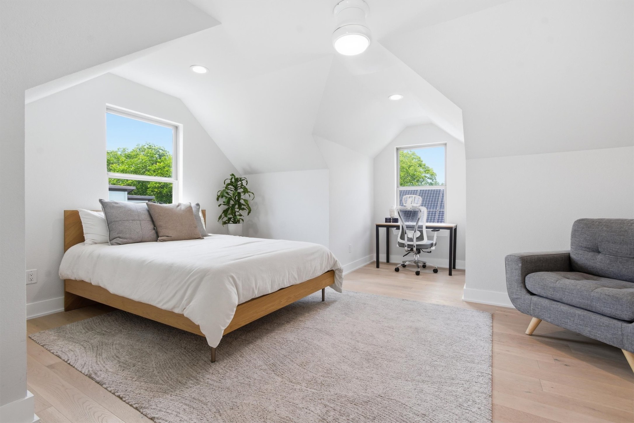 2710 Zaragosa Street, Unit A Austin, TX 78702 - Photo 22 of 29 Vaulted Loft Suite with soaring angled ceilings and a window-lined wall — a versatile fourth flex space.