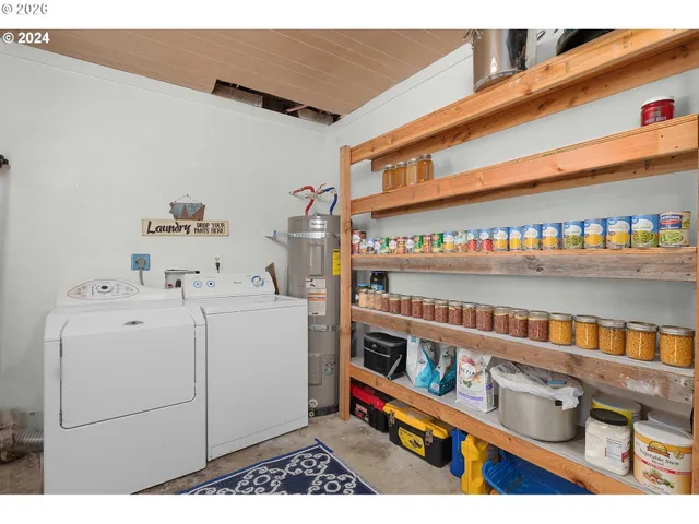 a view of a hallway with wooden floor and a living room