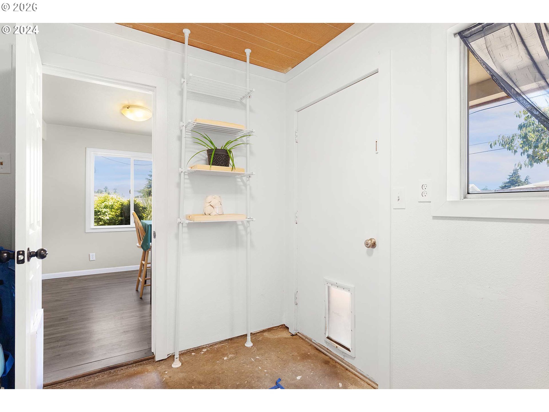 1669 Hayes Street North Bend, OR 97459 - Photo 18 of 30 a view of a hallway with wooden floor and a living room