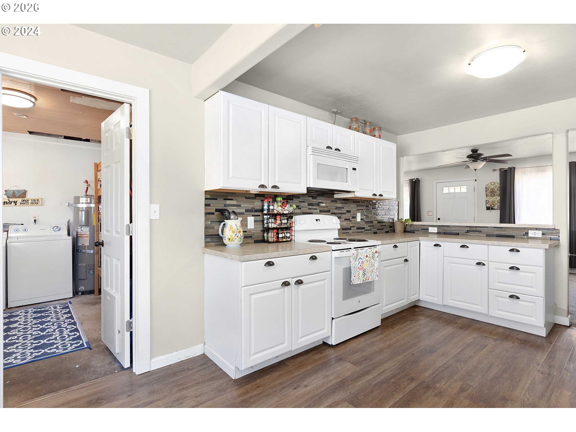 1669 Hayes Street North Bend, OR 97459 - Photo 2 of 30 a kitchen with cabinets a sink and white appliances