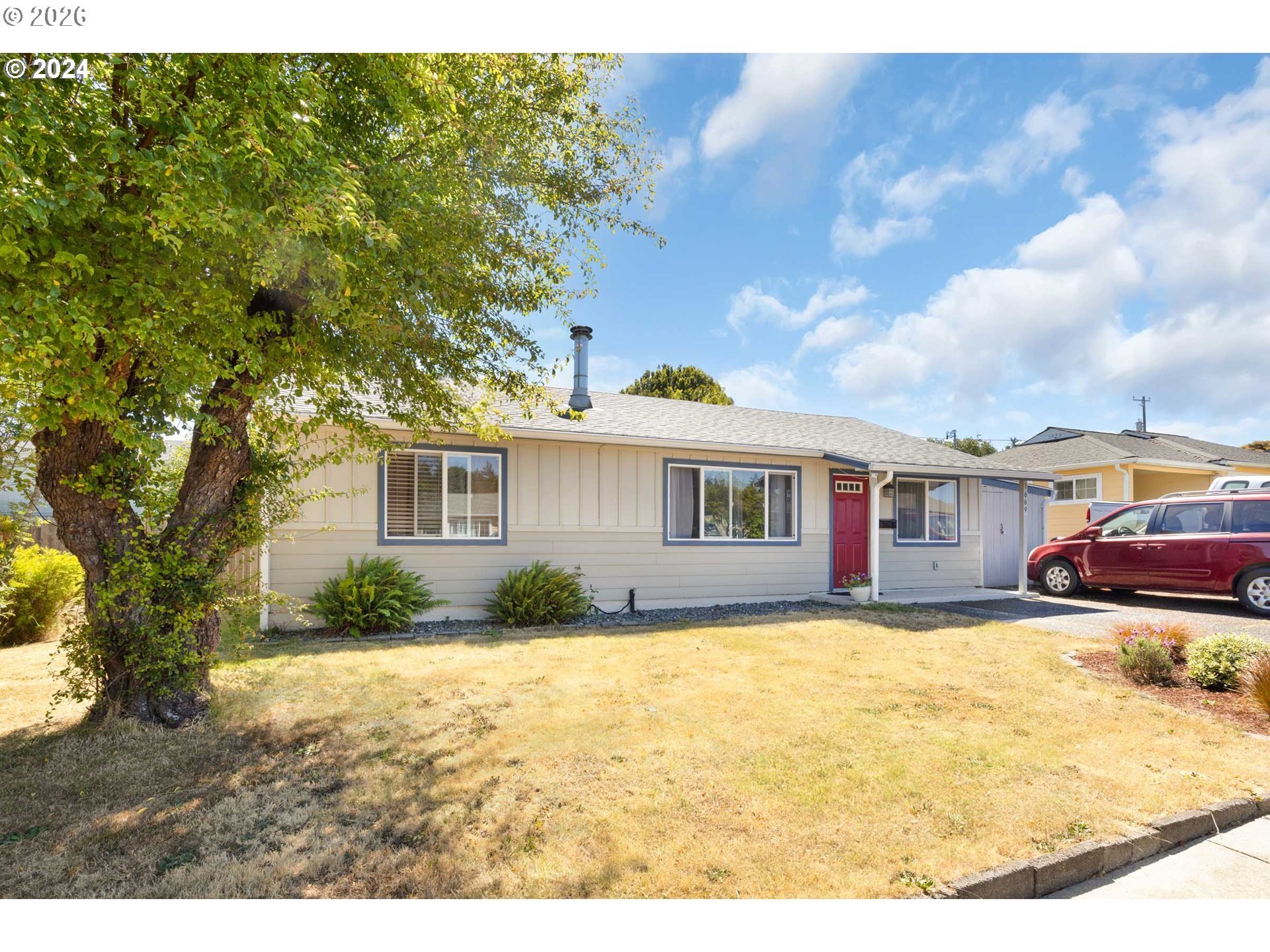 1669 Hayes Street North Bend, OR 97459 - Photo 22 of 30 a view of a yard in front of a house with a large tree