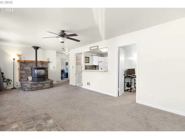 a kitchen with white cabinets and refrigerator