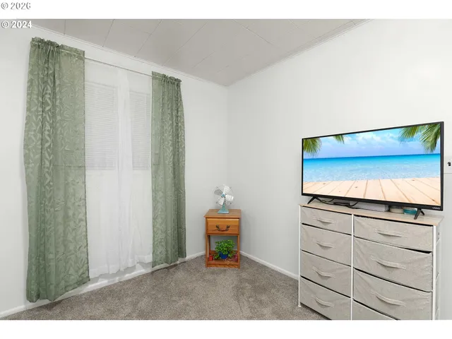 a living room with a bed and furniture