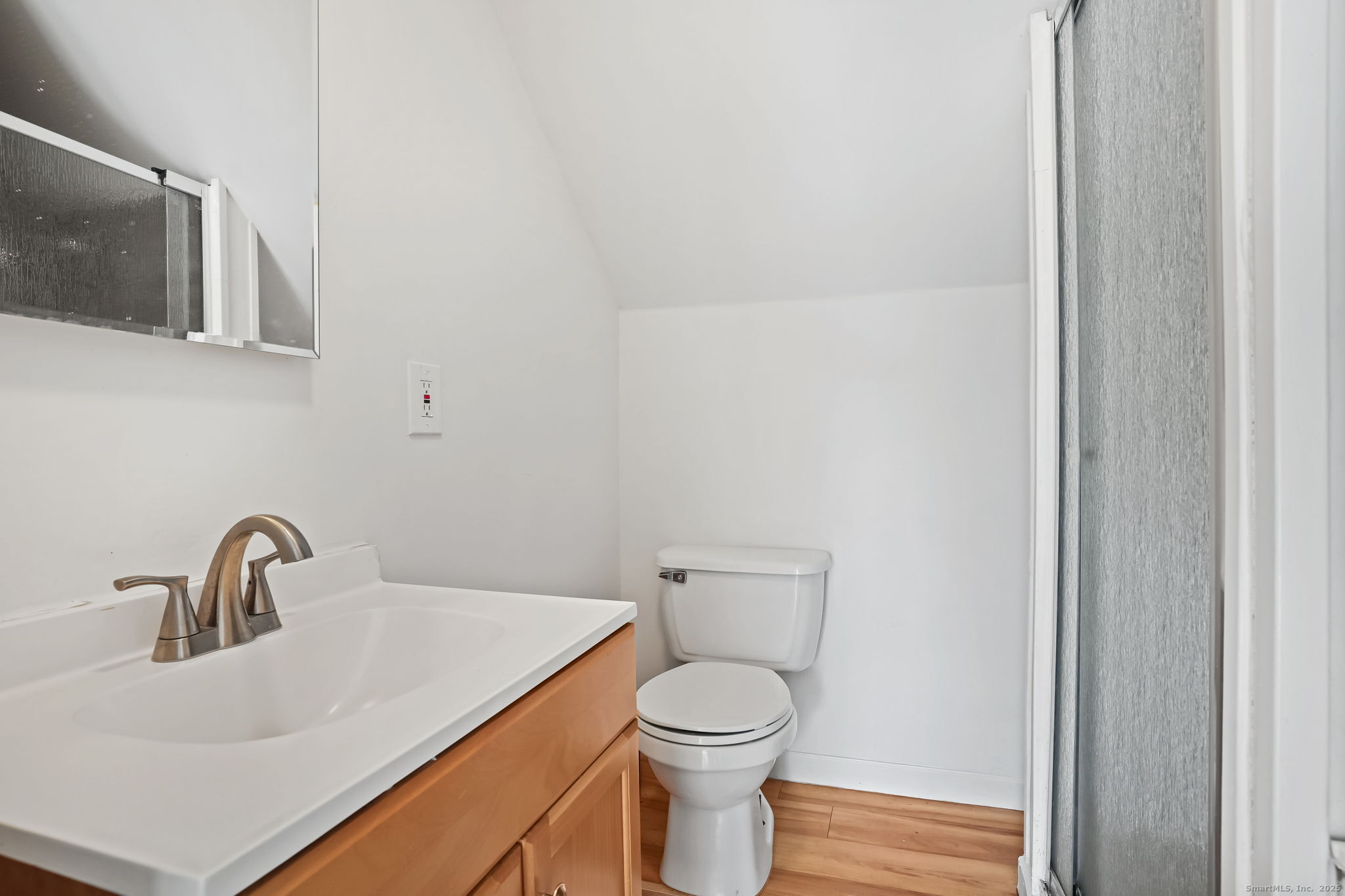 7 George Street, Unit 2 Torrington, CT 06790 - Photo 11 of 11 a bathroom with a toilet sink and mirror