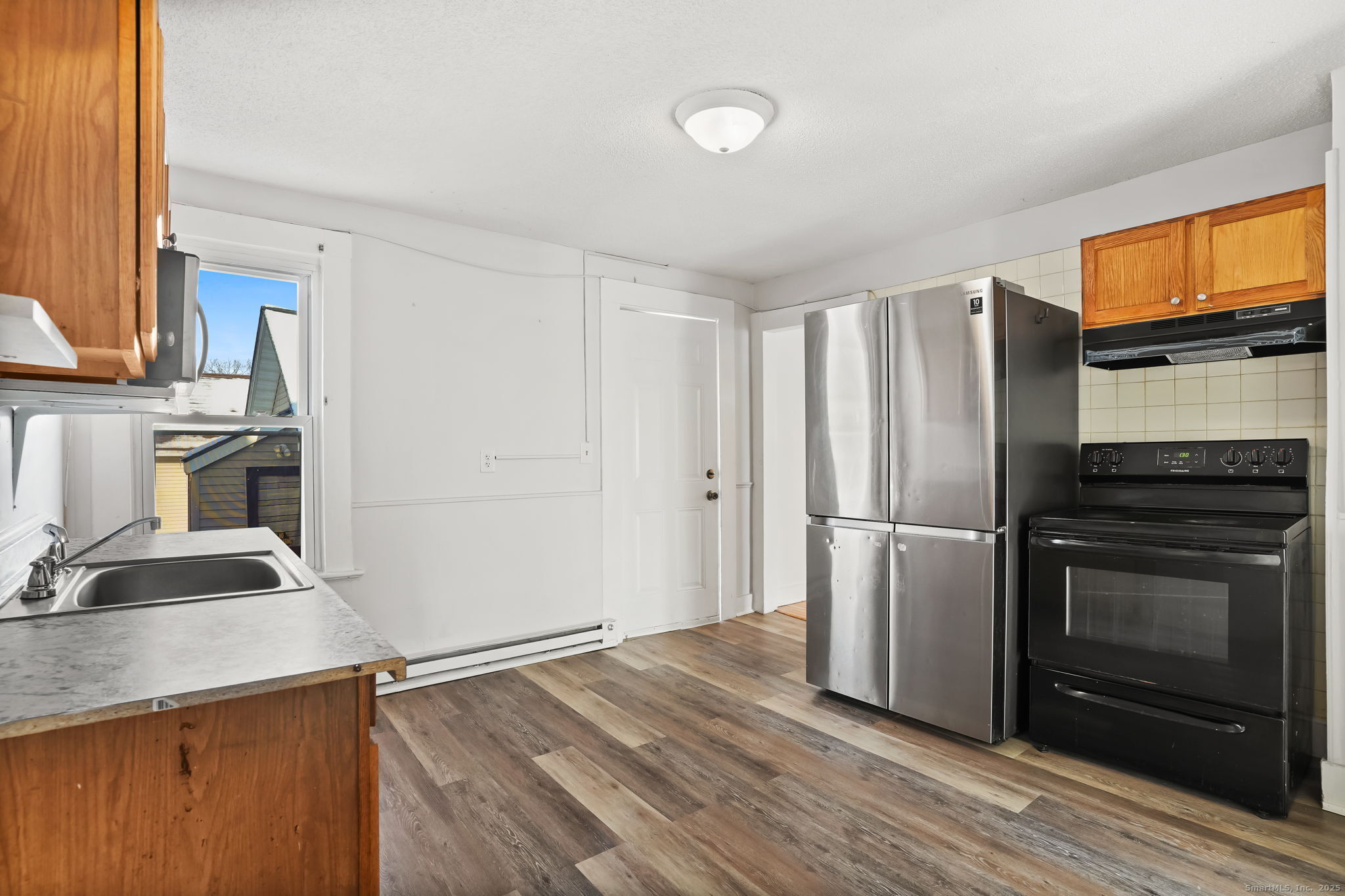7 George Street, Unit 2 Torrington, CT 06790 - Photo 4 of 11 a kitchen with a refrigerator stove and sink