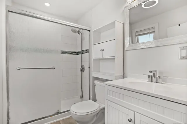 a bathroom with a sink toilet and shower