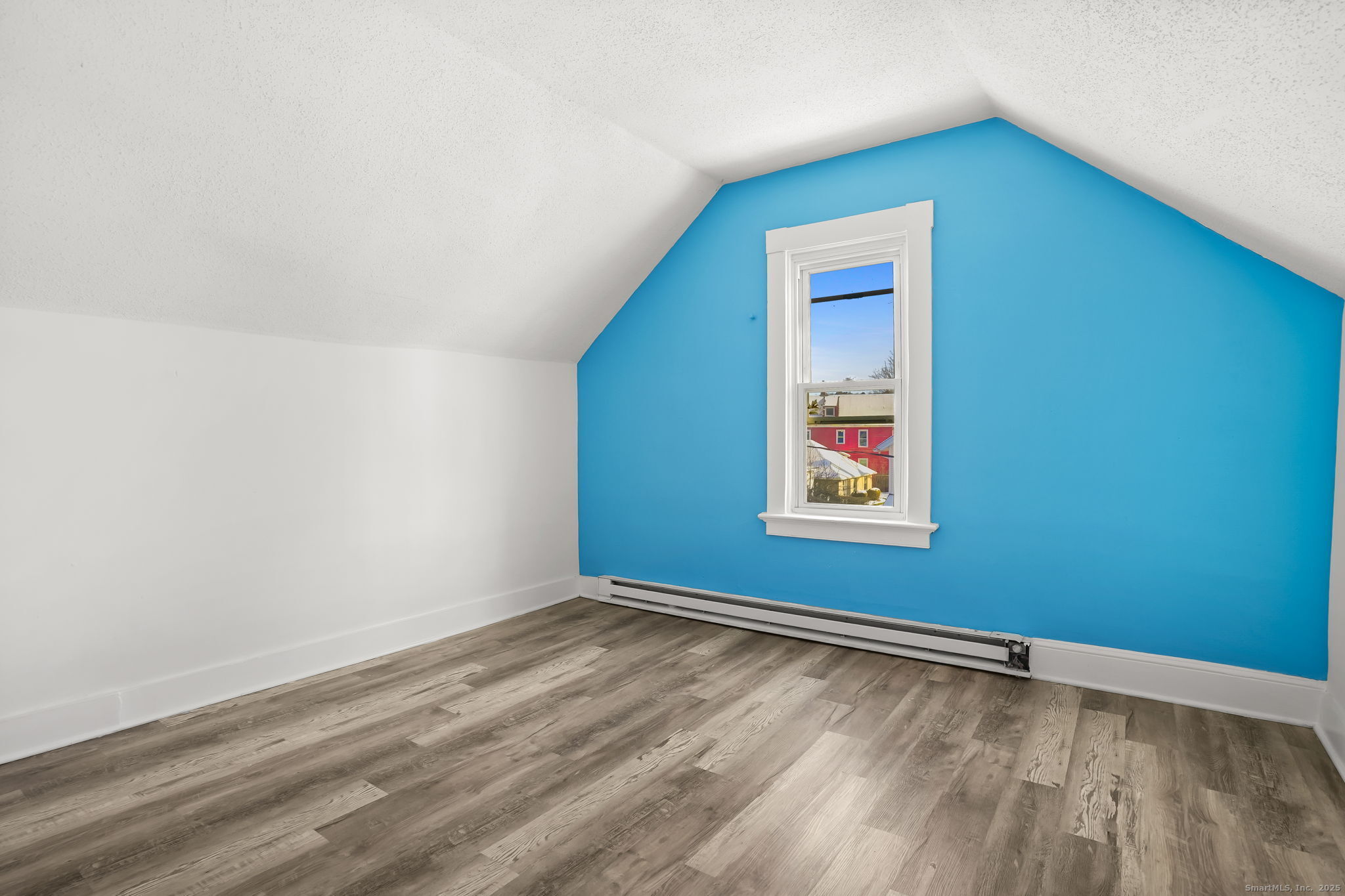 7 George Street, Unit 2 Torrington, CT 06790 - Photo 9 of 11 a view of an empty room with window and wooden floor