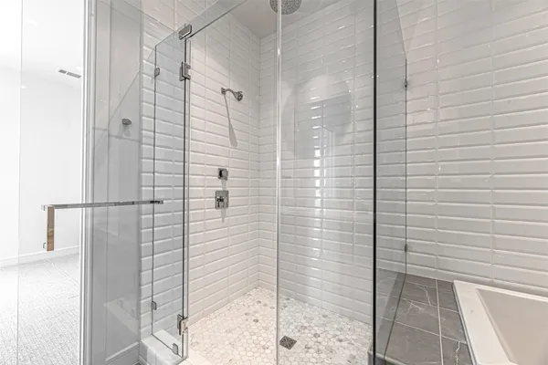 a bathroom with a shower and a sink