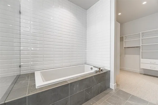 a bathroom with a bathtub and shower