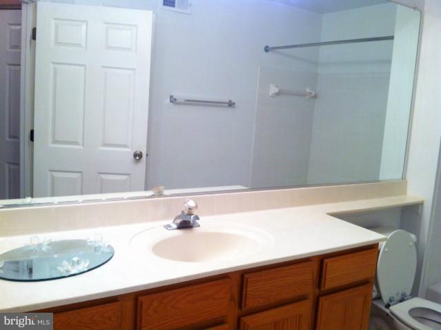 12008 Amber Ridge Circle, Unit A201 Germantown, MD 20876 - Photo 8 of 17 a bathroom with a sink and a mirror