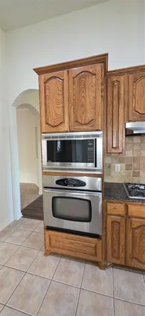 a kitchen with kitchen island a counter and a refrigerator