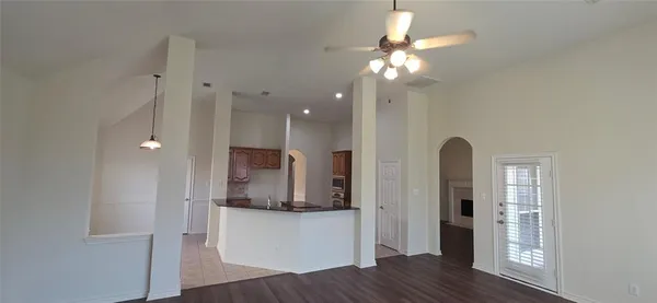 a view of a livingroom with wooden floor a chandelier