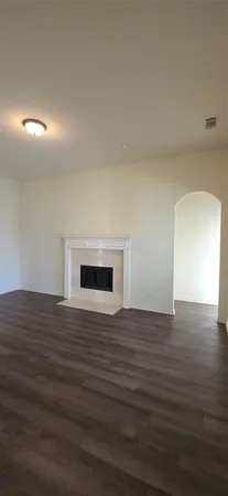 a view of a room with a chandelier fan and windows