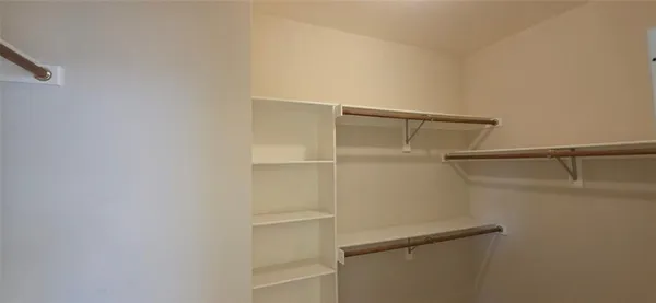 a view of a bathroom with mirror and shower