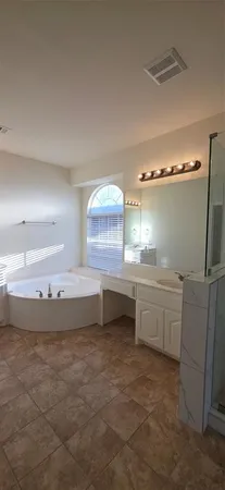 a bathroom with a shower and a sink