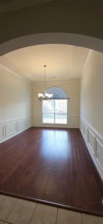 an empty room with wooden floor