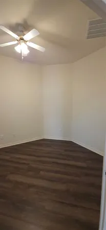 a view of an empty room with a fan