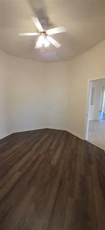 a view of a room with wooden floor and fan