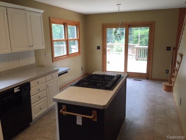 4833 Clements Circle Howell, MI 48855 - Photo 3 of 27 kitchen with island and breakfast area and door to deck
