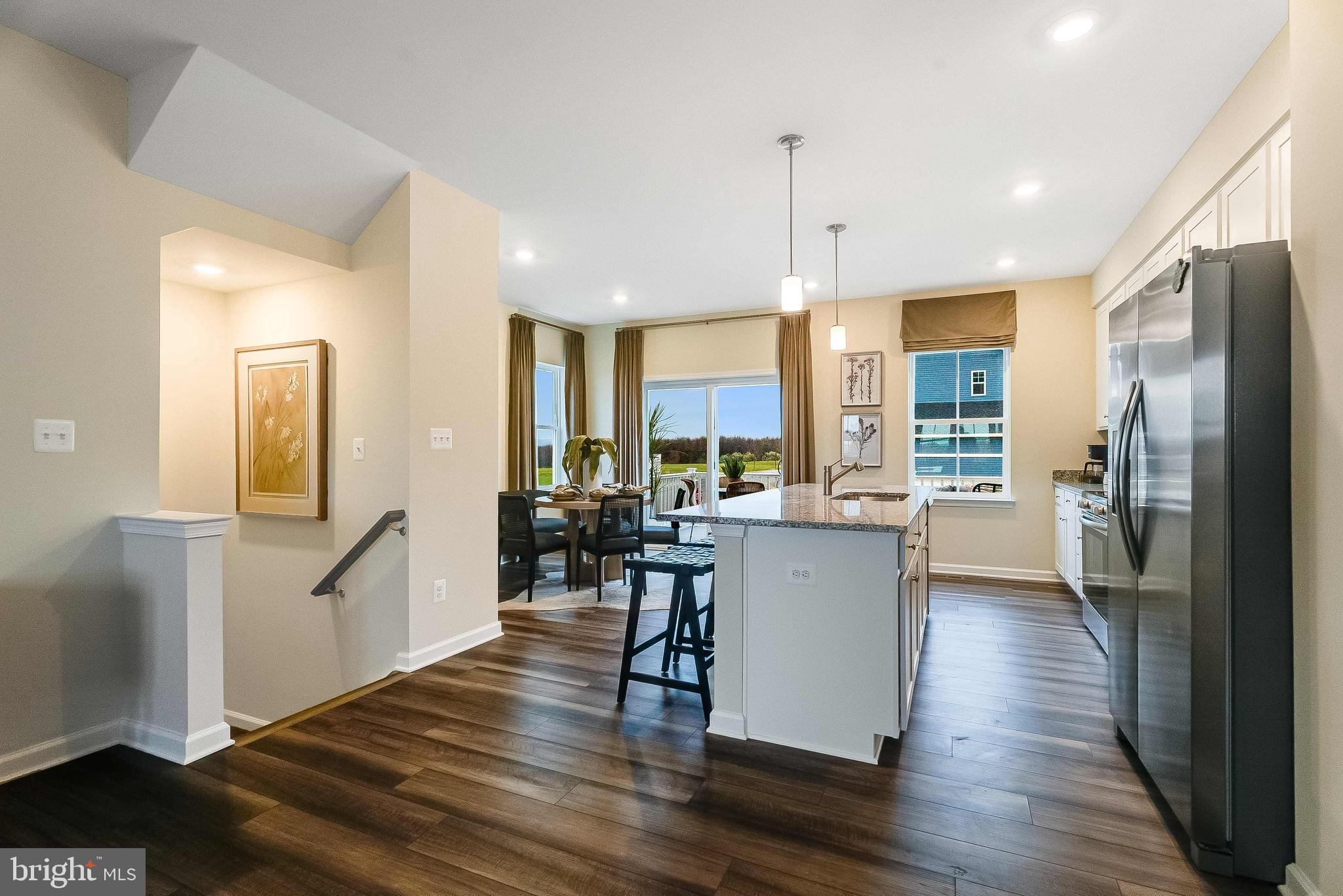 1252 Red Clover Lane Ranson, WV 25438 - Photo 7 of 24 a kitchen with a table chairs refrigerator and window