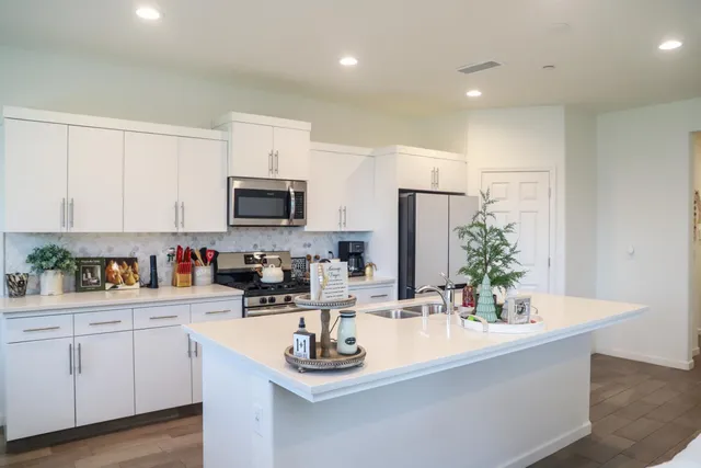 a kitchen with white cabinets and a sink