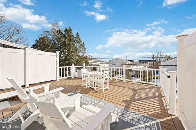 a view of a patio with a table and chairs and wooden floor