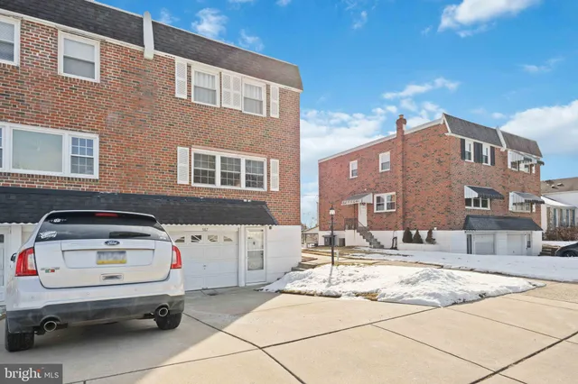 a front view of a building with parking space